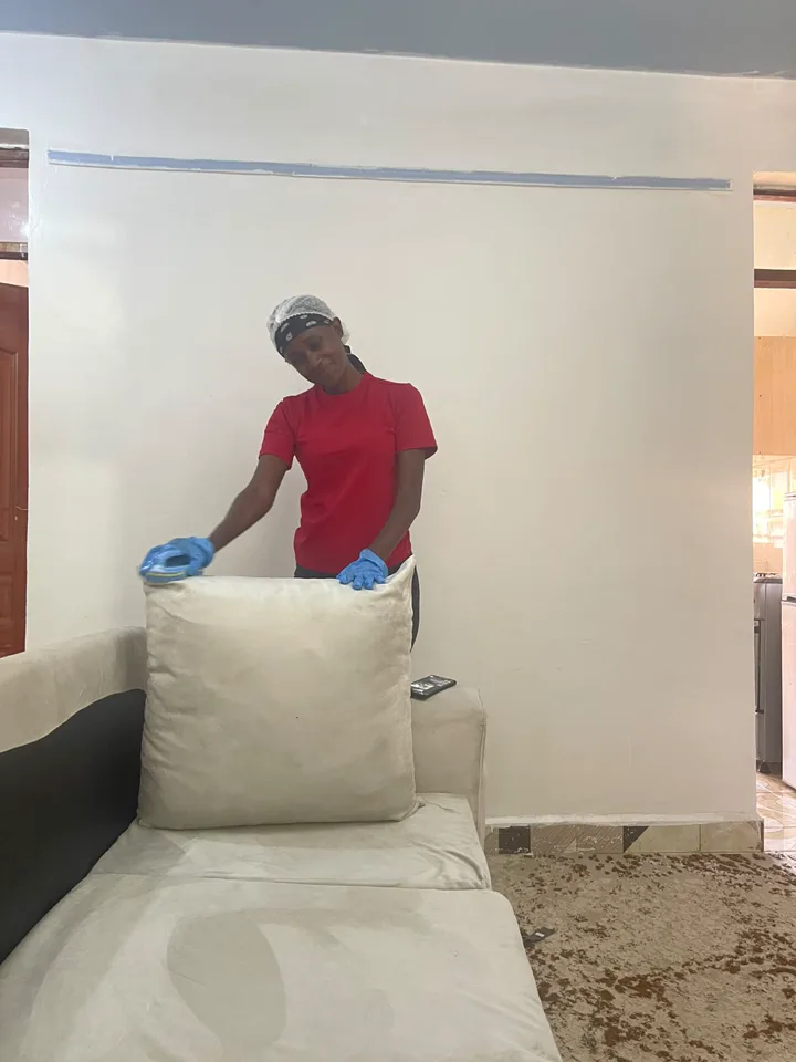 FreshDream team member carefully preparing a sofa cushion for cleaning
